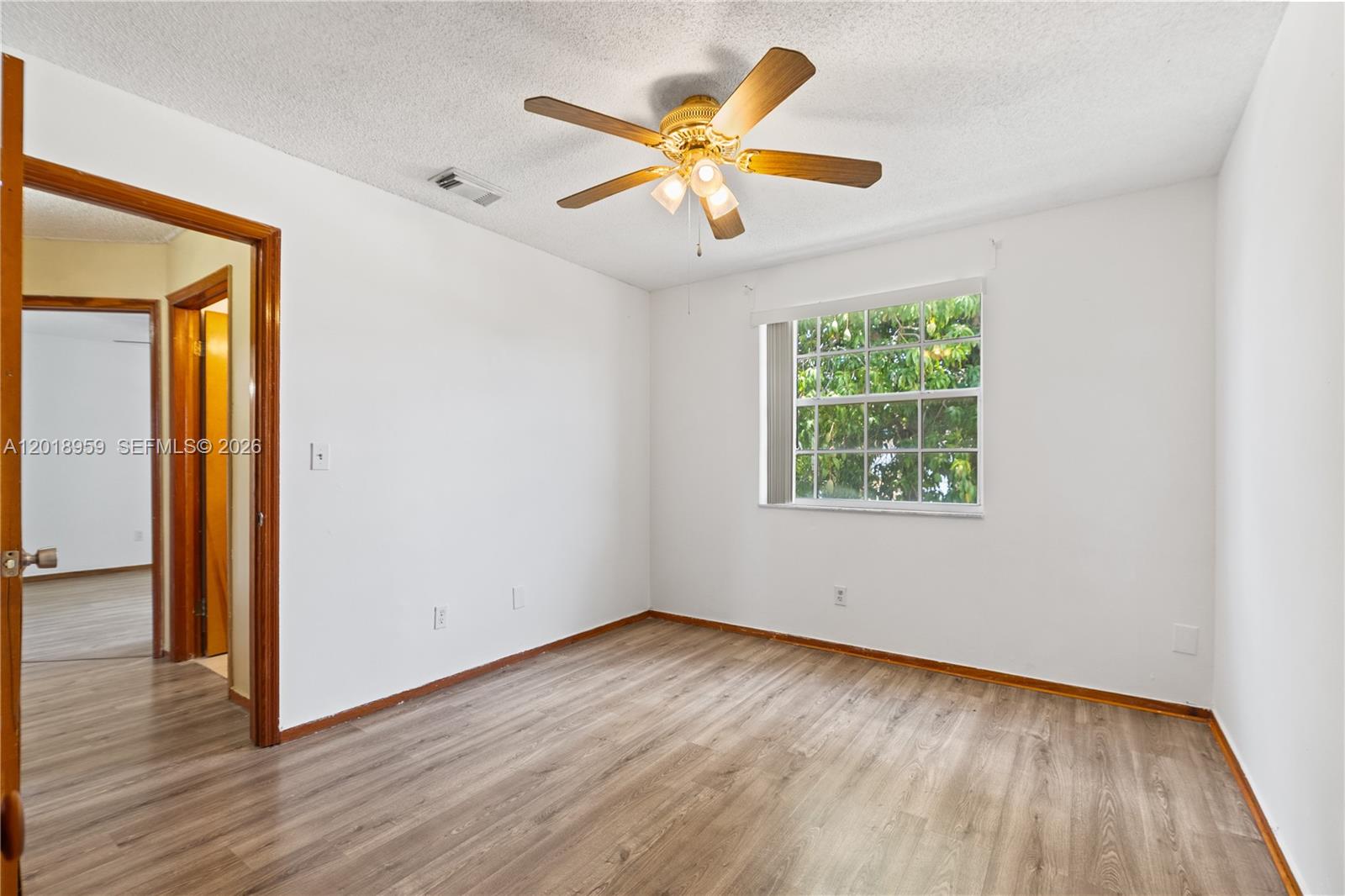 15345 Southwest 63rd Terrace Miami, FL 33193 - Photo 23 of 51 an empty room with wooden floor and windows