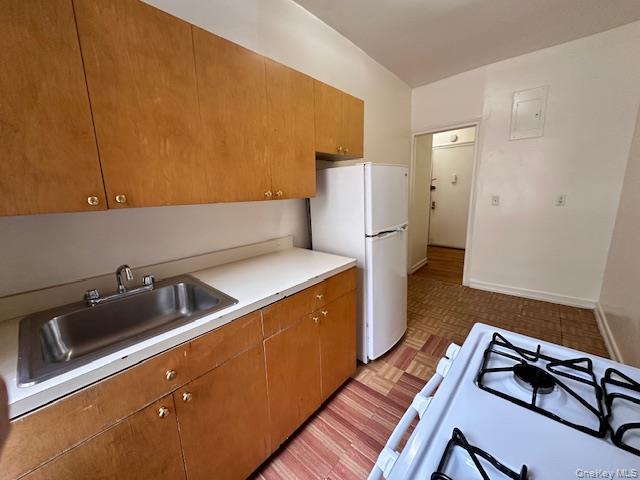 225 Bennett Avenue, Unit 2R Manhattan, NY 10040 - Photo 14 of 25 a kitchen with stainless steel appliances a sink a stove and a refrigerator