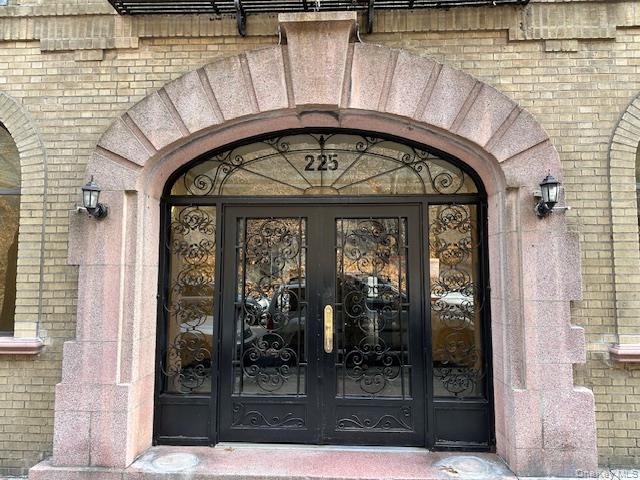 225 Bennett Avenue, Unit 2R Manhattan, NY 10040 - Photo 6 of 25 Doorway to property featuring brick siding and french doors