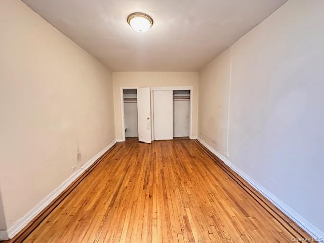 225 Bennett Avenue, Unit 2R Manhattan, NY 10040 - Photo 6 of 25 an empty room with wooden floor