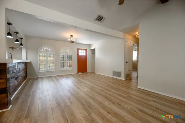 wooden floor in an empty room with a fireplace