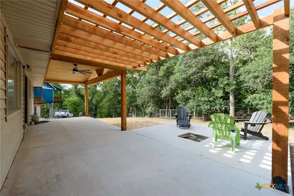 a view of a patio with table and chairs and potted plants