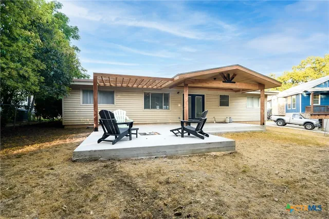a front view of a house with swimming pool and porch