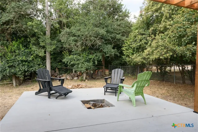 a view of backyard with sitting area