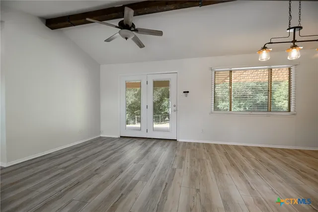 a view of room with hardwood floor and window