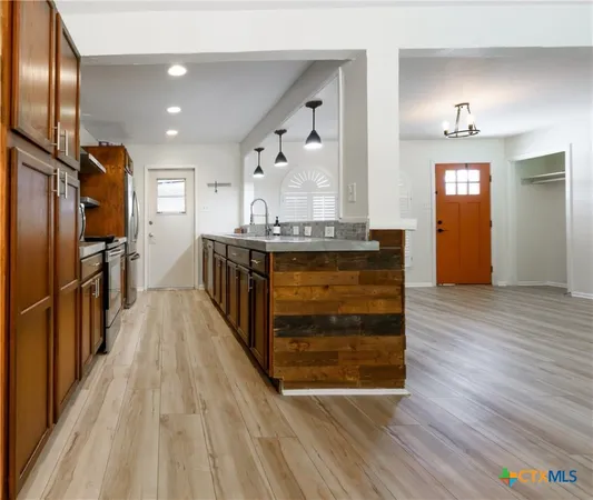a view of kitchen with cabinets and wooden floor