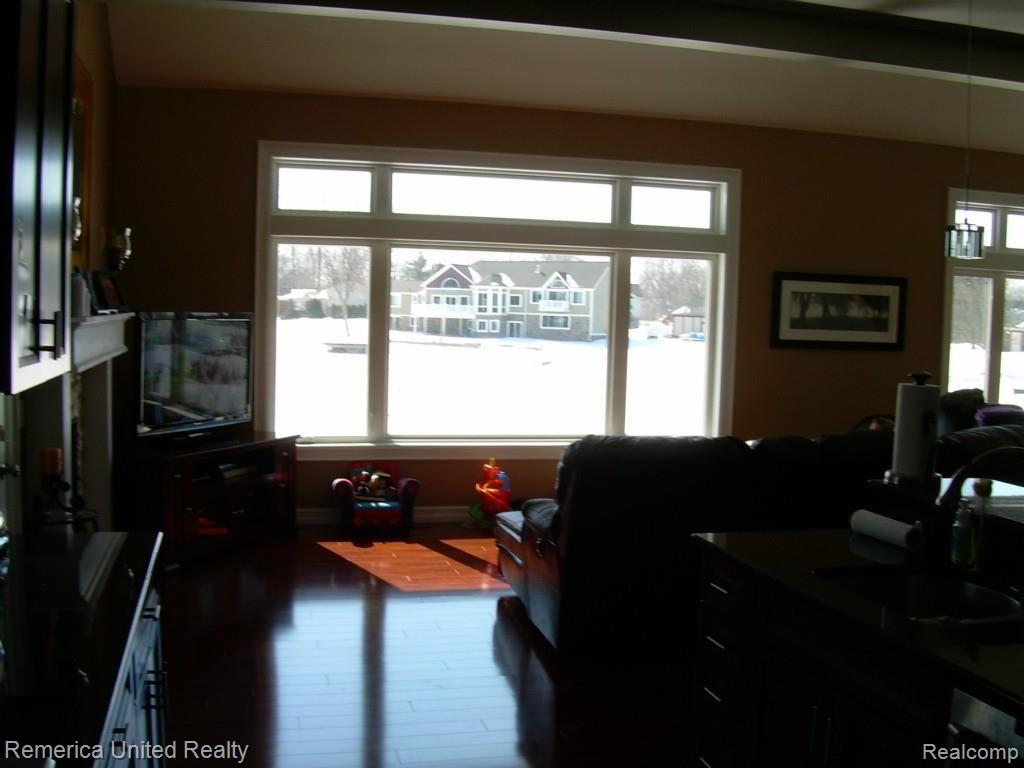 3467 East Commerce Road Commerce Township, MI 48382 - Photo 15 of 36 Hearth room with large windows for amazing views and natural sunlight.