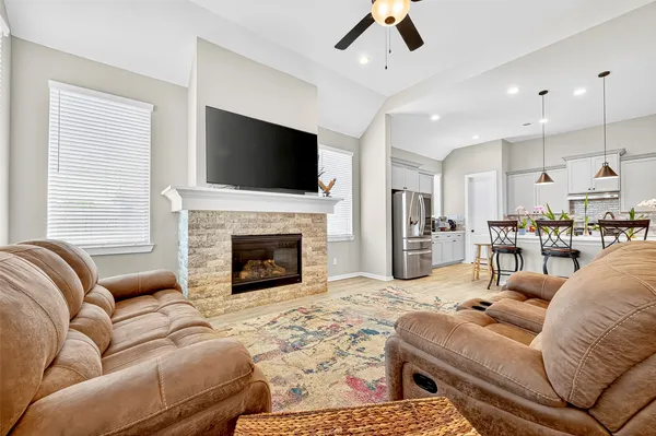 a living room with furniture fireplace and flat screen tv