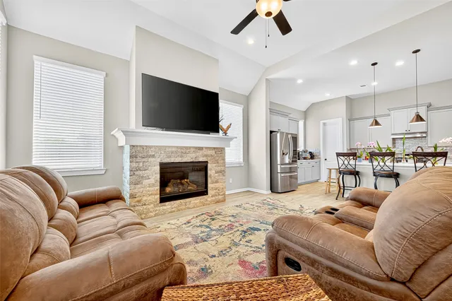 a living room with furniture fireplace and flat screen tv
