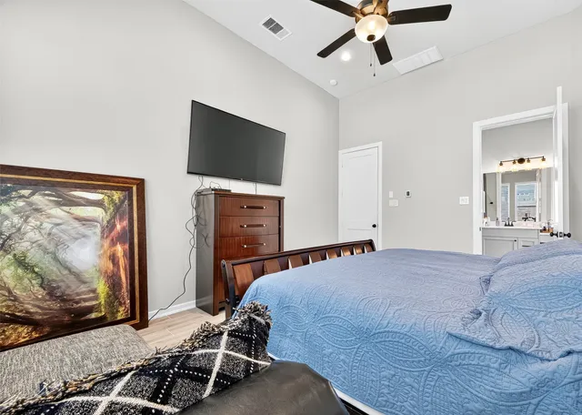 a bedroom with a bed and a flat screen tv