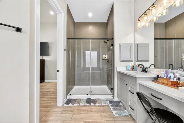 a bathroom with a double vanity sink a mirror and a shower