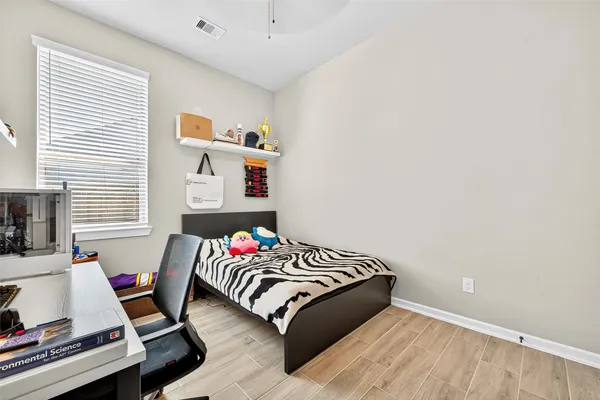 a bedroom with a bed and a window