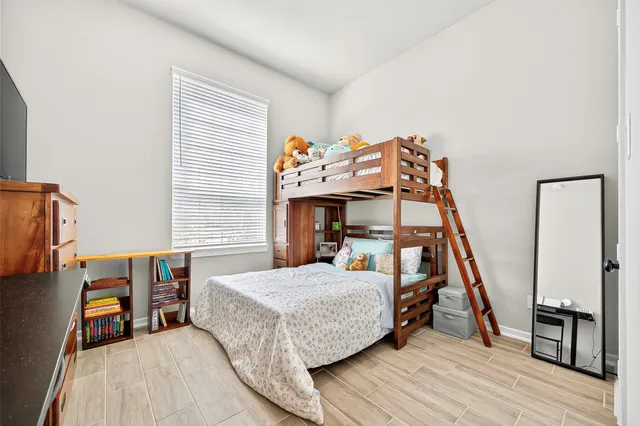 a bedroom with a bed and a tv on table