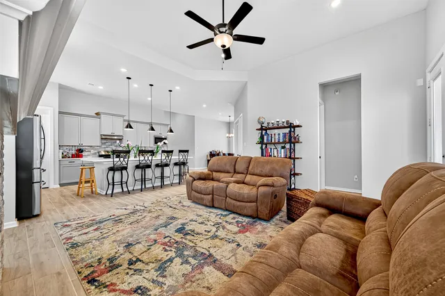 a living room kitchen with furniture and kitchen view