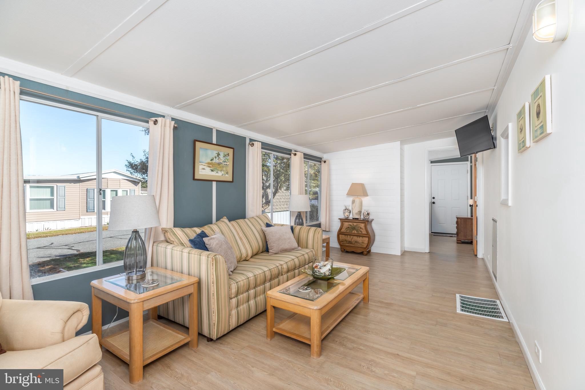380 Seahawk Lane Berlin, MD 21811 - Photo 19 of 72 a living room with furniture and a large window