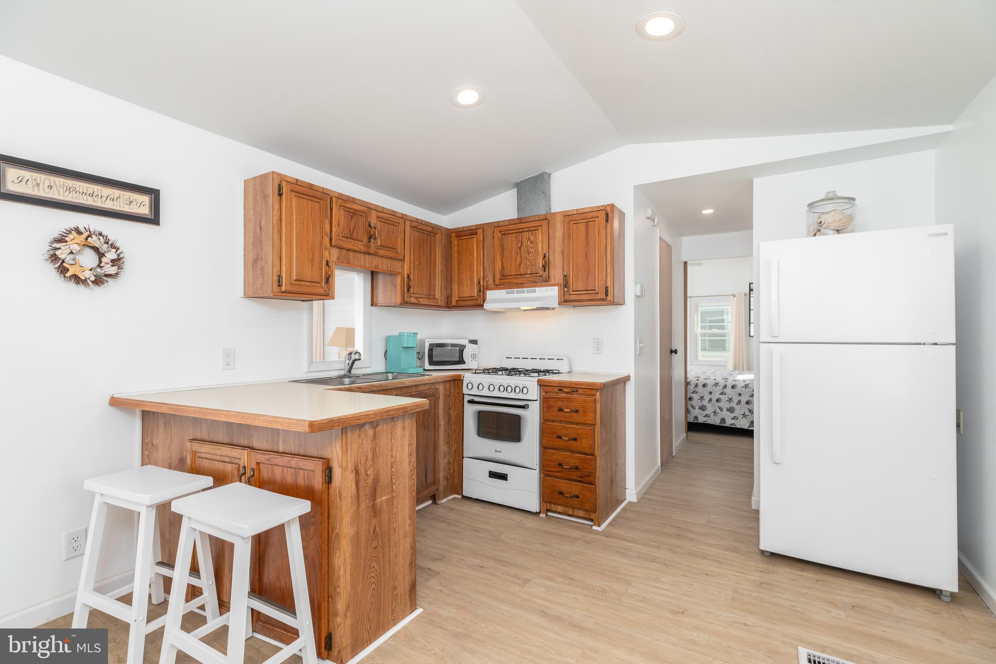 380 Seahawk Lane Berlin, MD 21811 - Photo 23 of 72 a kitchen with a stove a refrigerator and a sink