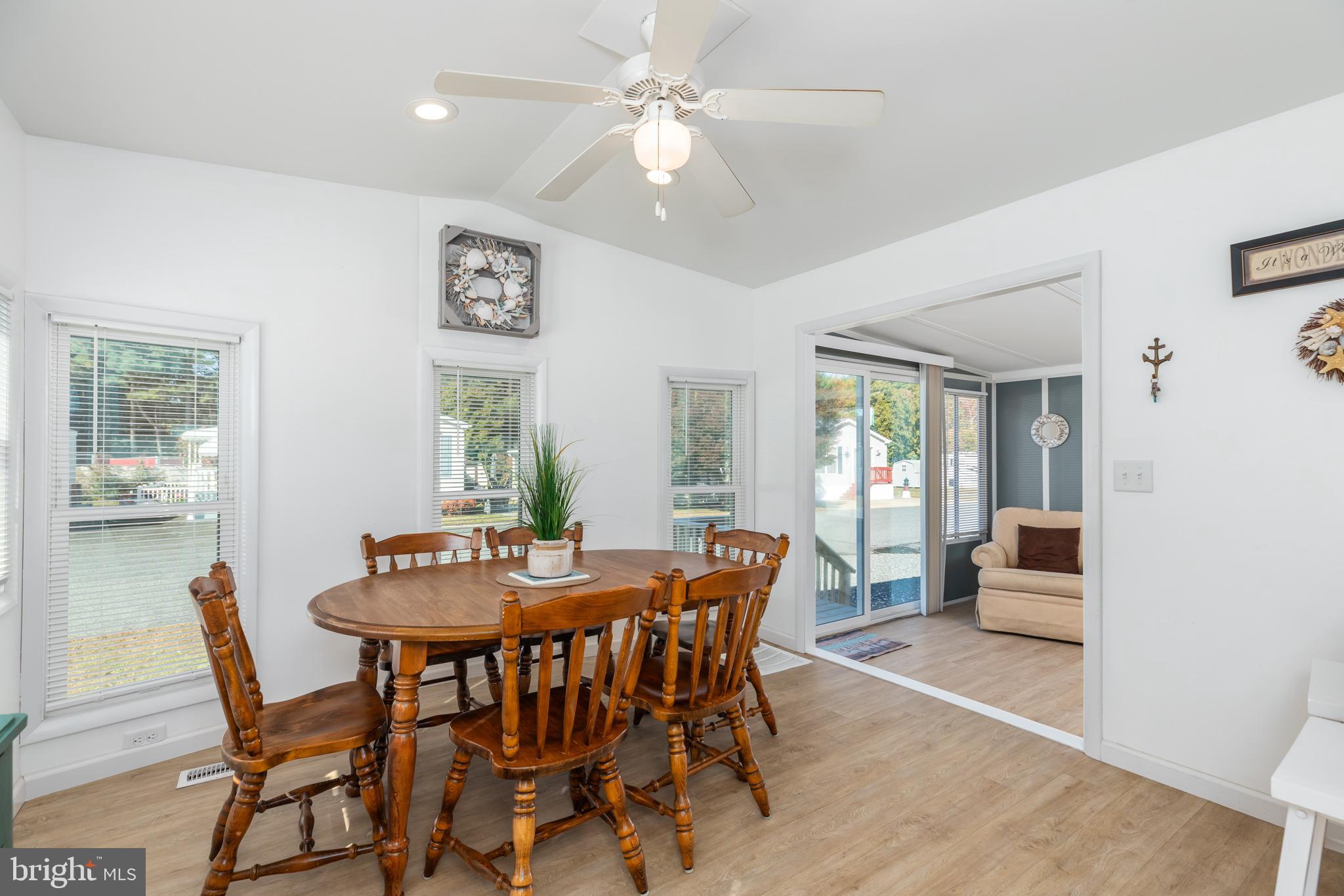 380 Seahawk Lane Berlin, MD 21811 - Photo 24 of 72 a view of a dining room with furniture window and wooden floor
