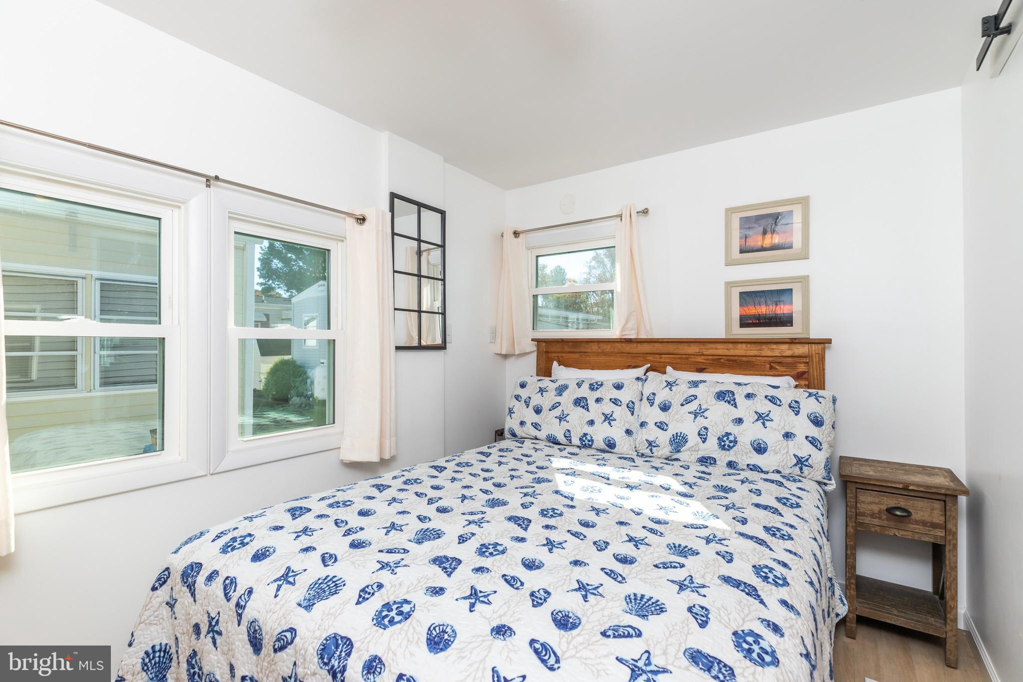 380 Seahawk Lane Berlin, MD 21811 - Photo 29 of 72 a bedroom with a large bed and a window
