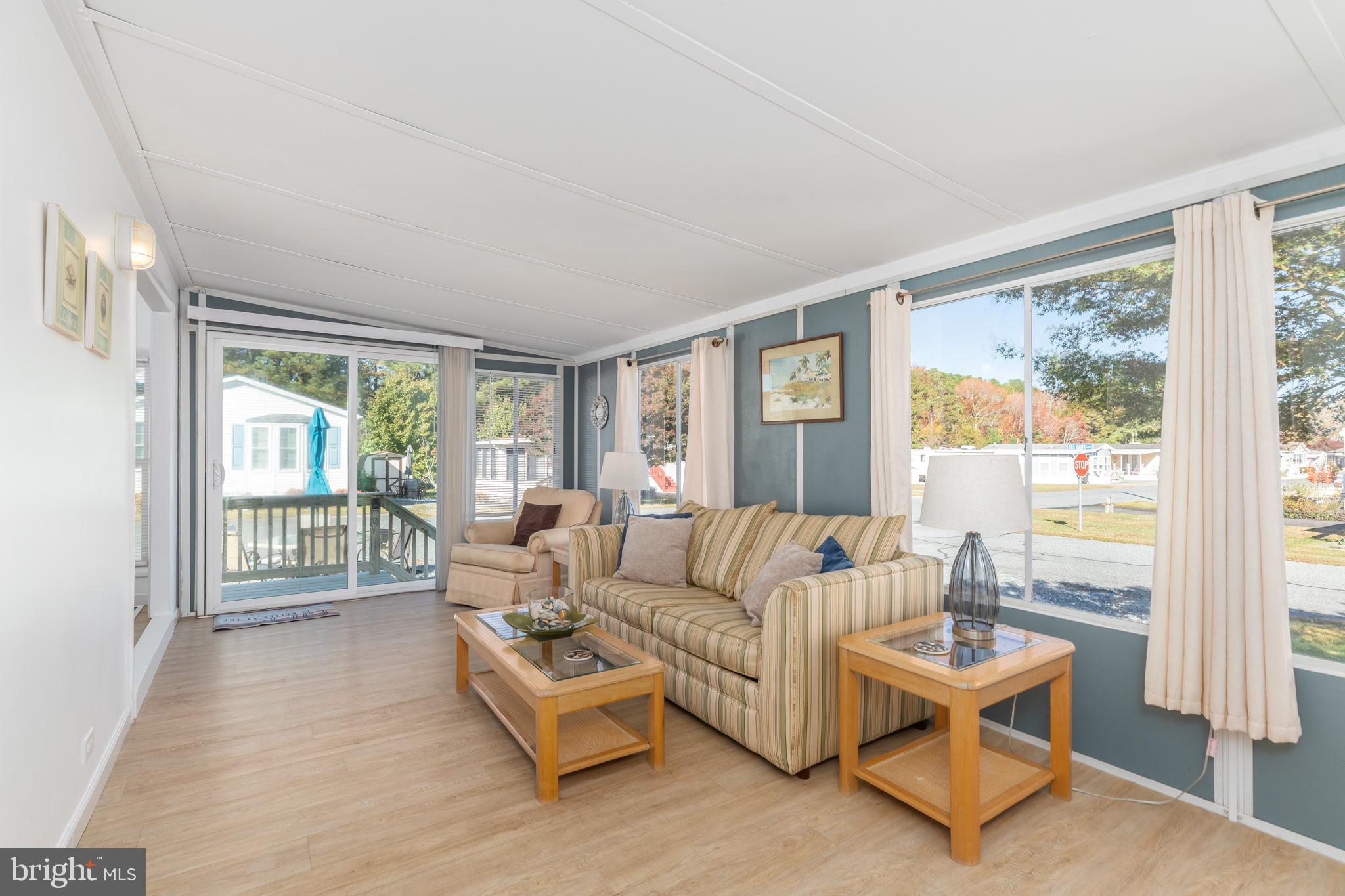380 Seahawk Lane Berlin, MD 21811 - Photo 31 of 72 a living room with furniture and a window with outer view