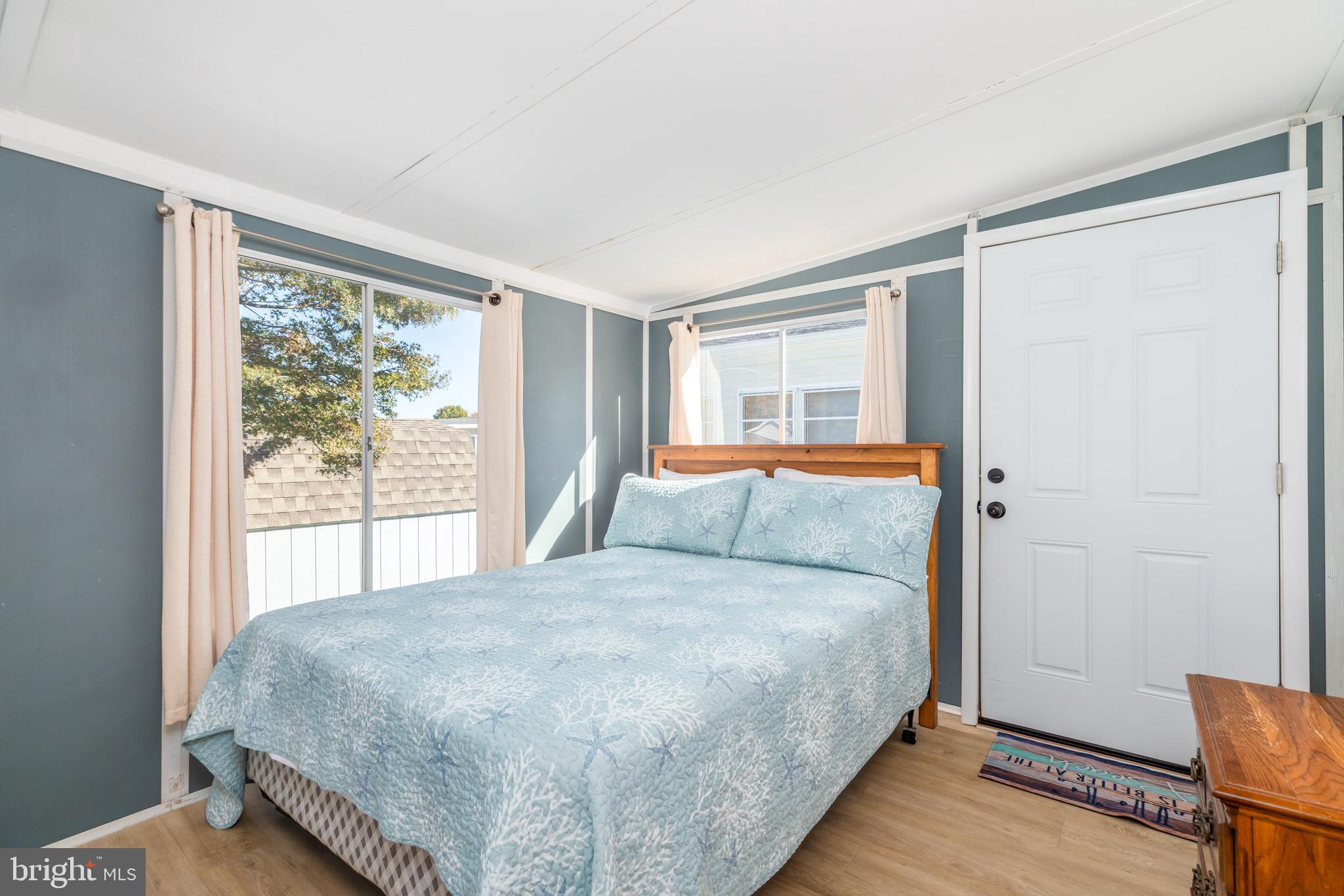 380 Seahawk Lane Berlin, MD 21811 - Photo 33 of 72 a bedroom with a large bed and a large window