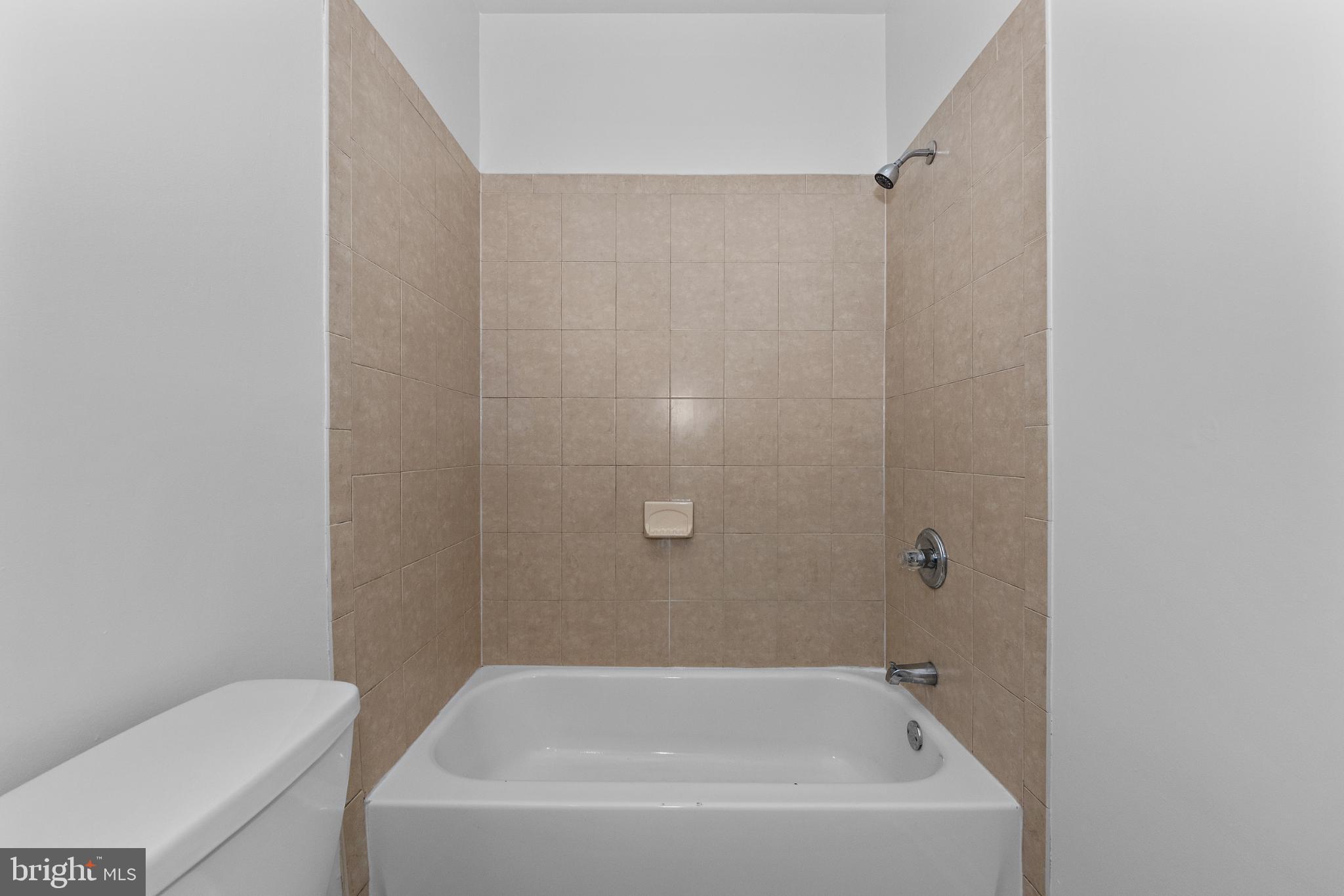 2409 Bryan Place Southeast Washington, DC 20020 - Photo 11 of 43 Modern bathroom with sleek tub and tiles.