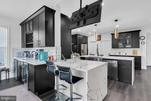 a kitchen with stainless steel appliances kitchen island granite countertop a sink and cabinets