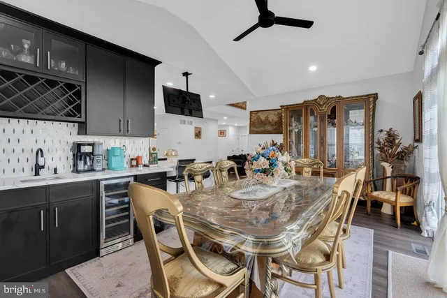 a large kitchen with stainless steel appliances kitchen island granite countertop a large stove a sink dishwasher and a flat screen tv