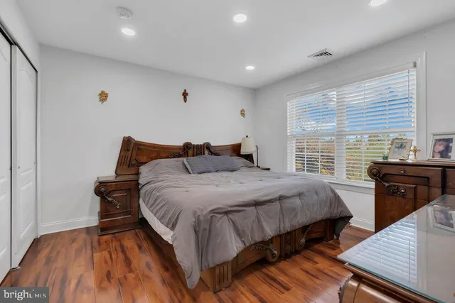 a bathroom with a granite countertop sink a toilet and a large mirror