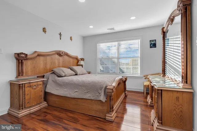 a bedroom with furniture and a flat screen tv