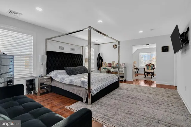 a bedroom with a bed and a television