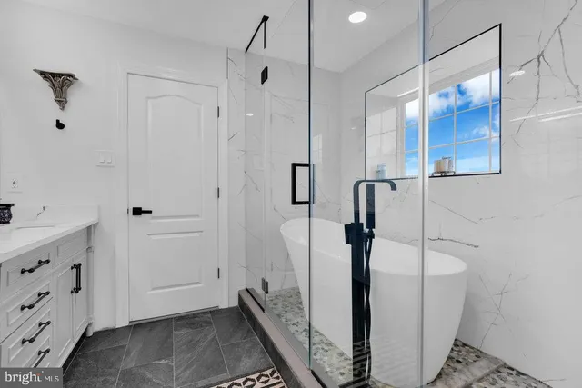 a spacious bathroom with a double vanity sink a mirror and a shower