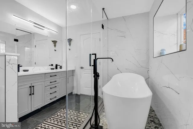 a view of a hallway with wooden floor and furniture