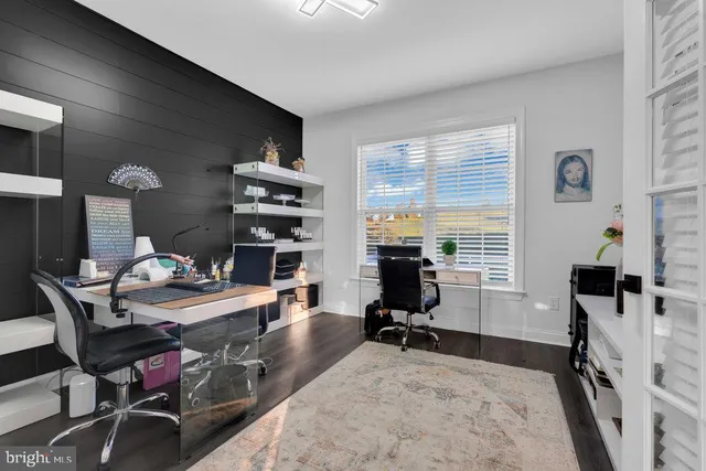 a living room with furniture and a dining table with kitchen view