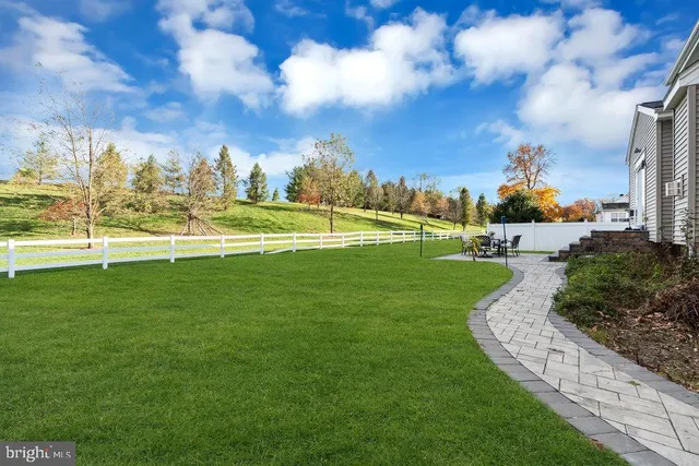a front view of a house with a garden and plants