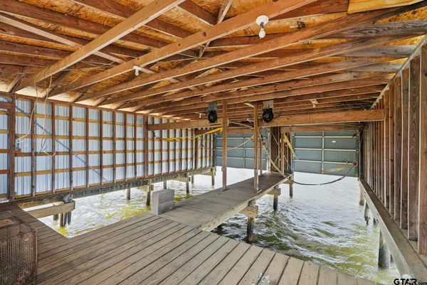 a roof deck with wooden floor and glass door