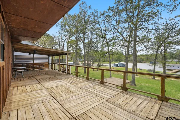 a view of backyard with deck and wooden floor