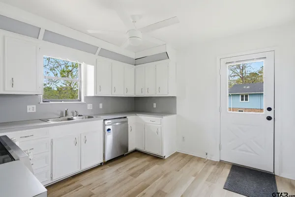 a kitchen with a sink cabinets and window