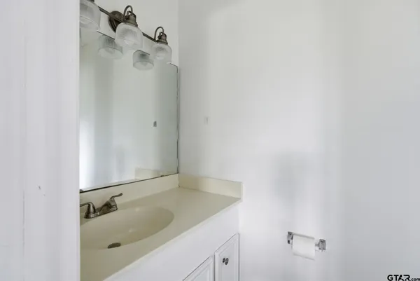 a bathroom with a sink and mirror
