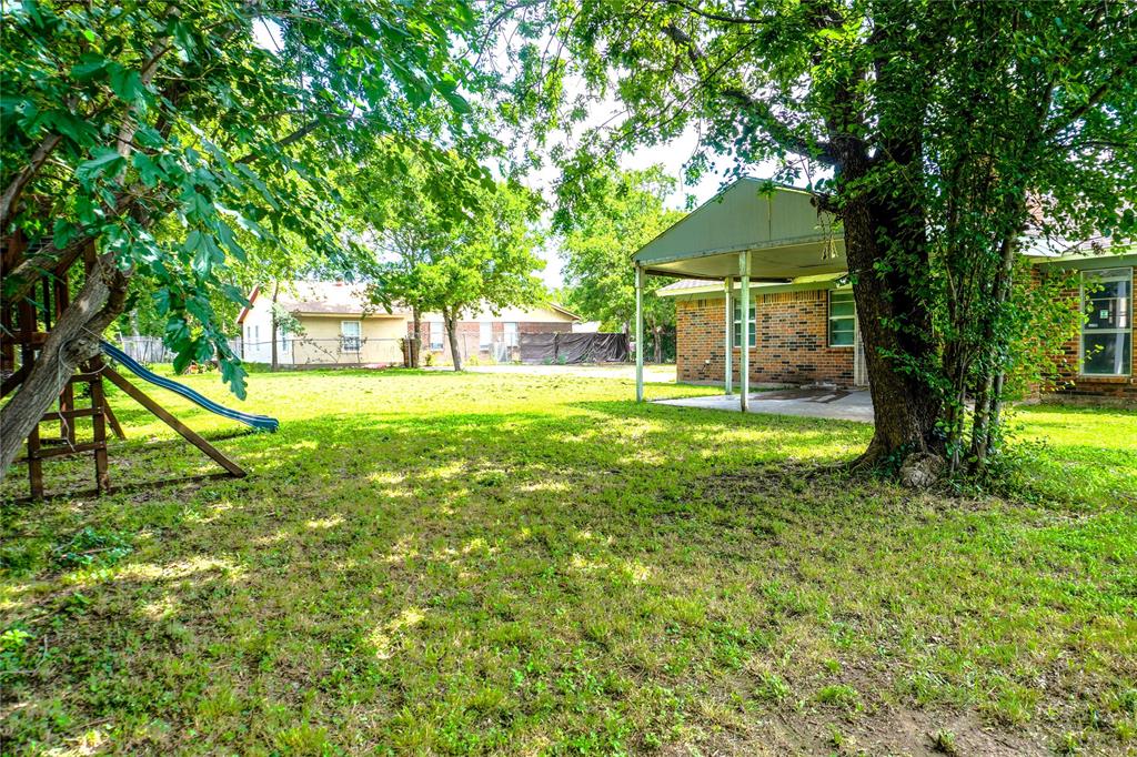 300 Coury Road Everman, TX 76140 - Photo 21 of 29 a view of a backyard with a small cabin