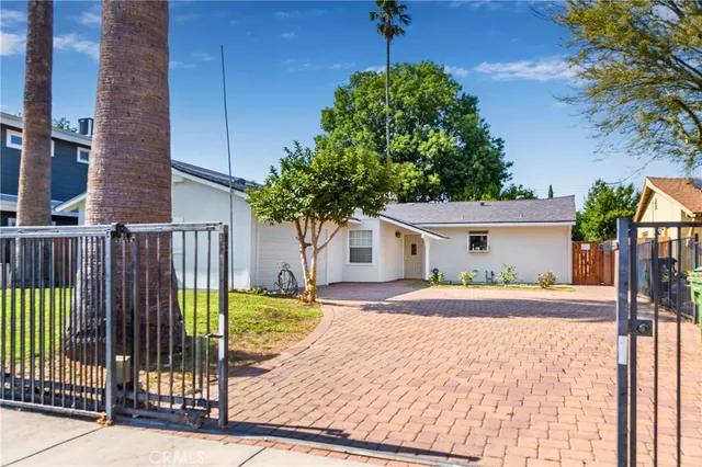 a white house that has a tree in front of it