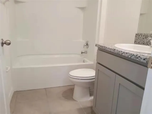 a bathroom with a toilet a sink and bathtub