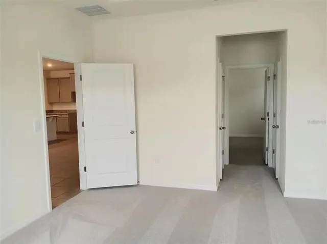 a view of an empty room and closet