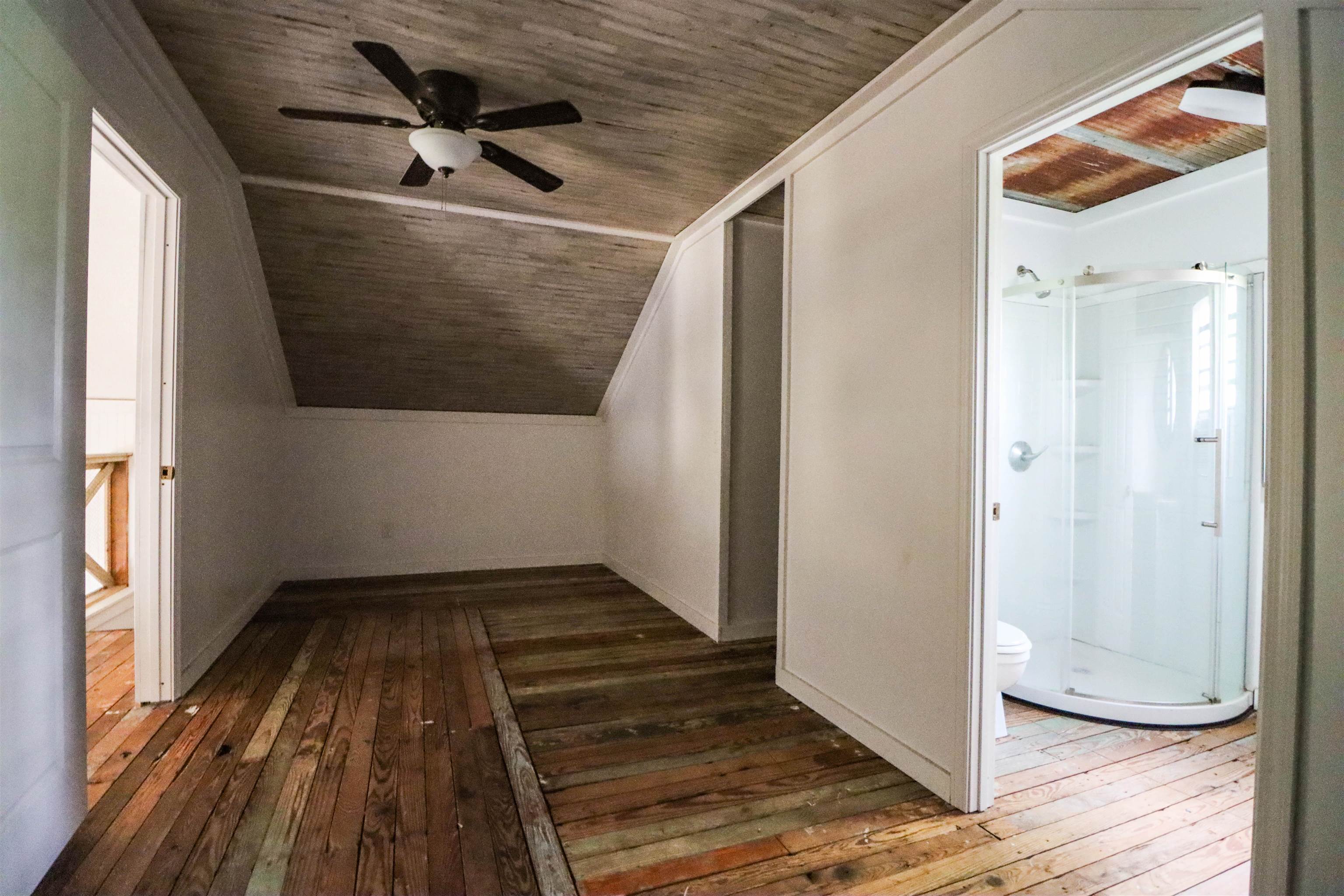 283 Forked Deer Road Ripley, TN 38063 - Photo 18 of 23 a view of an empty room with wooden floor and a window
