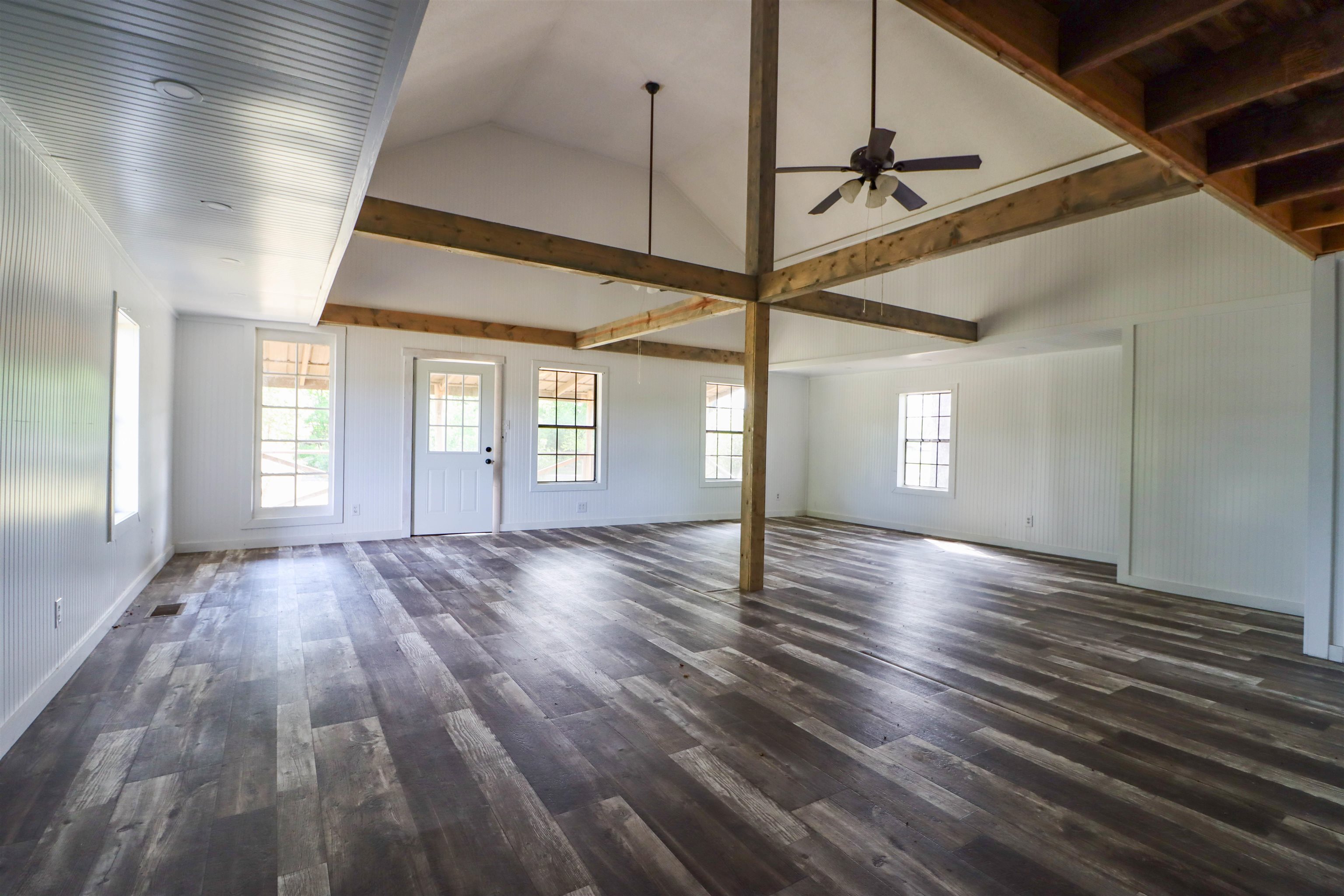 283 Forked Deer Road Ripley, TN 38063 - Photo 4 of 23 a view of an empty room with window and wooden floor