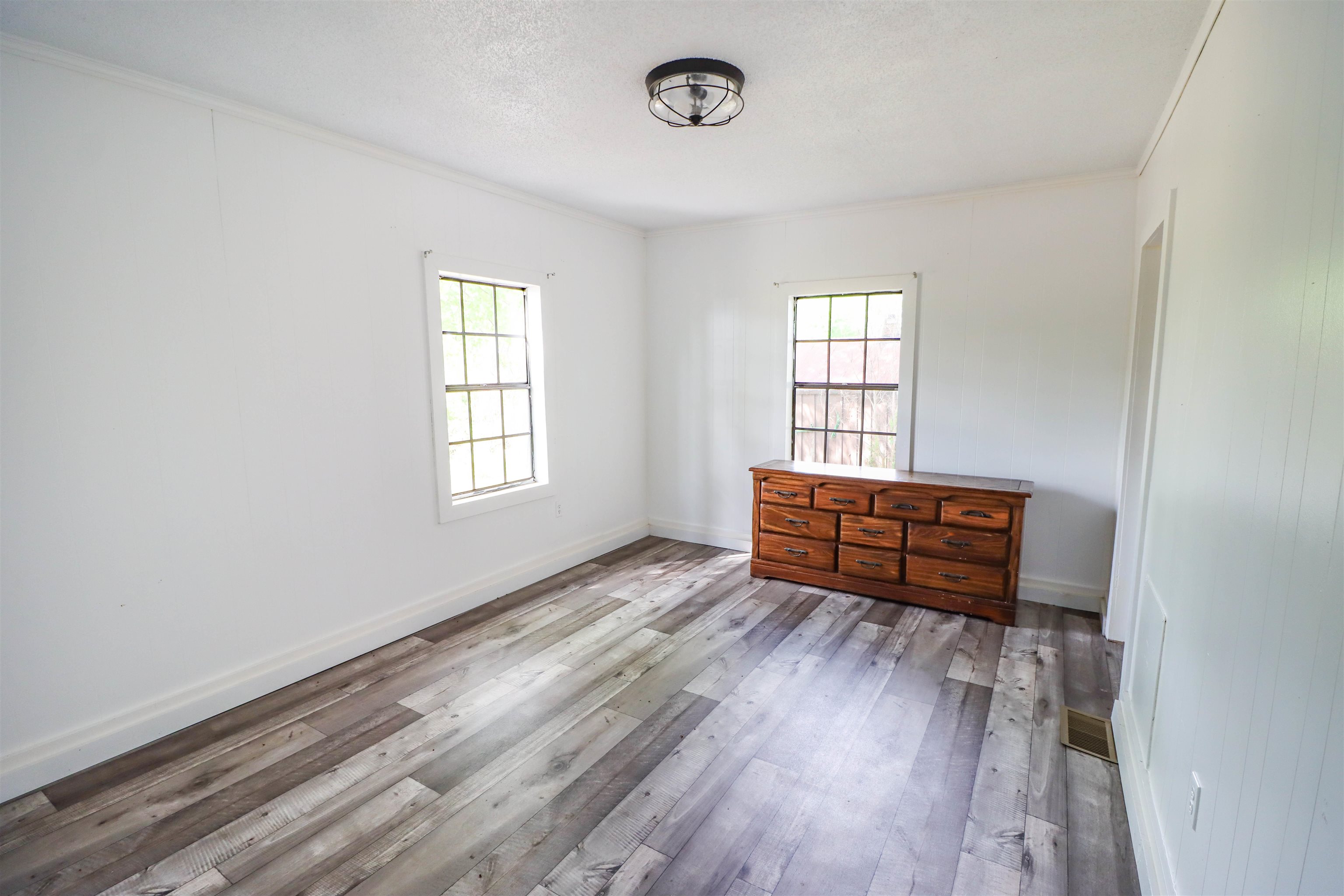 283 Forked Deer Road Ripley, TN 38063 - Photo 5 of 23 an empty room with wooden floor and windows