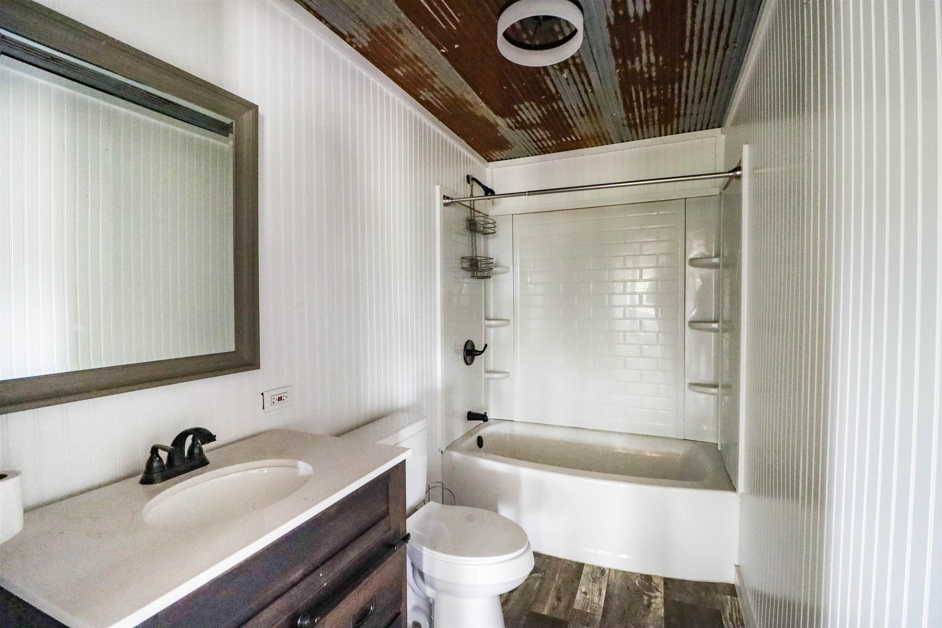 283 Forked Deer Road Ripley, TN 38063 - Photo 7 of 23 a bathroom with a sink a toilet and a bathtub