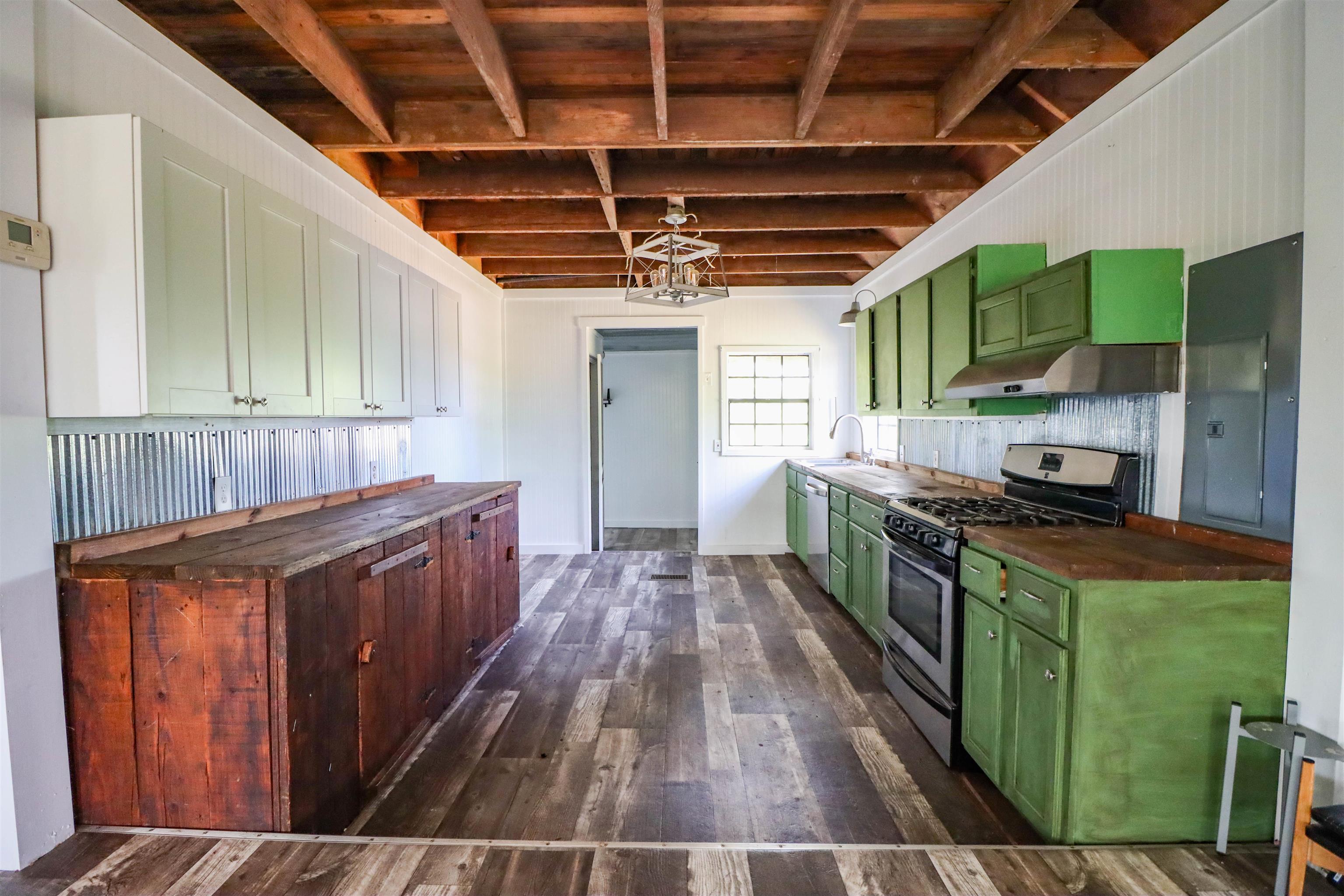 283 Forked Deer Road Ripley, TN 38063 - Photo 10 of 23 a kitchen with stainless steel appliances granite countertop a stove a sink dishwasher a refrigerator and a oven with wooden cabinets