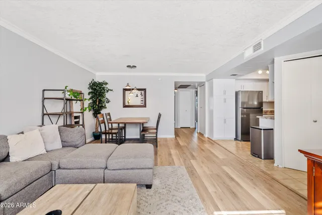 a living room with furniture and kitchen view