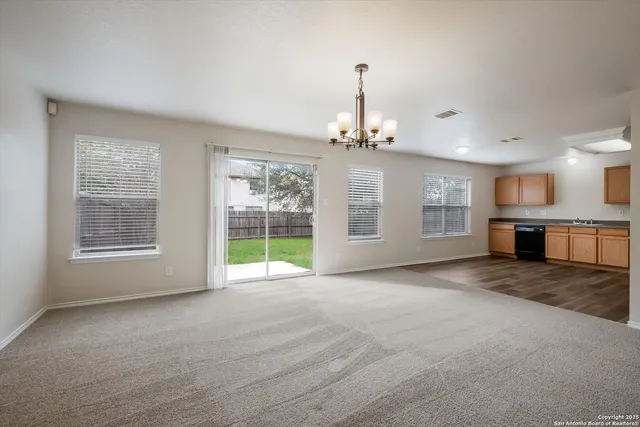 a view of an empty room with a window and fireplace