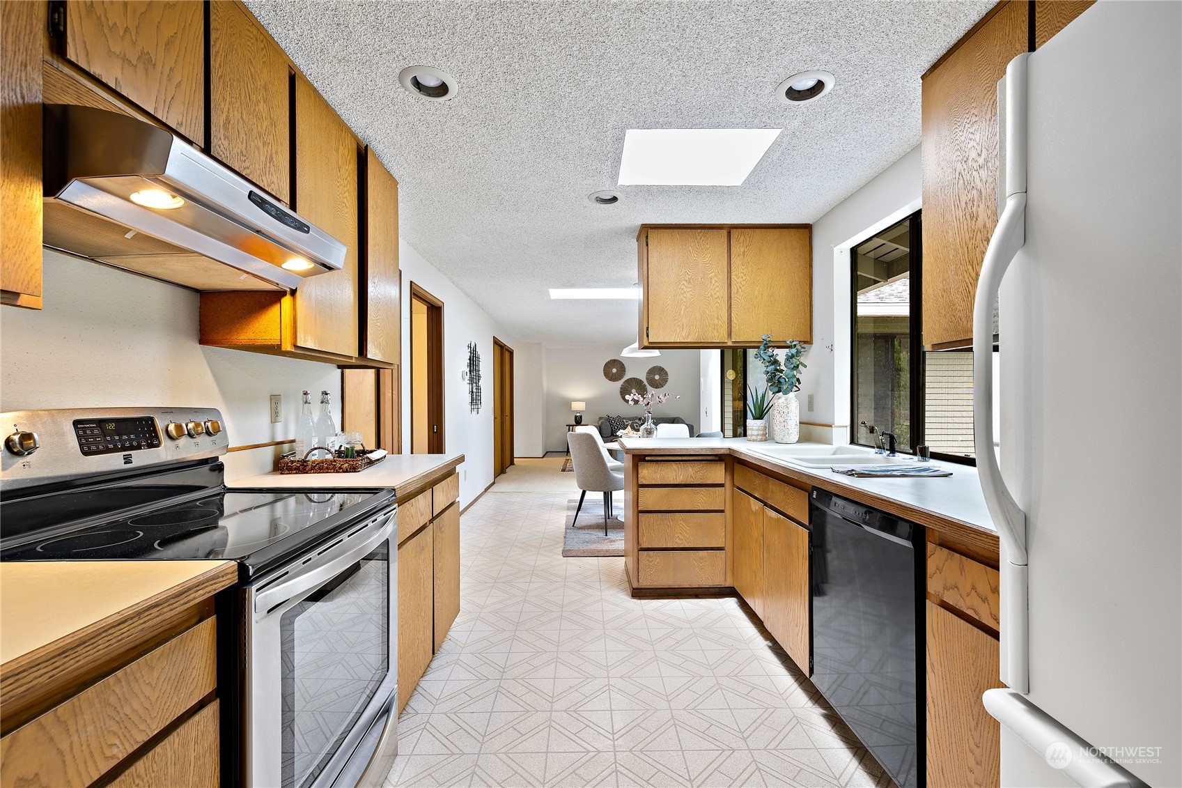 40 Chelan Key Bellevue, WA 98006 - Photo 9 of 29 a kitchen with stainless steel appliances granite countertop sink stove and cabinets